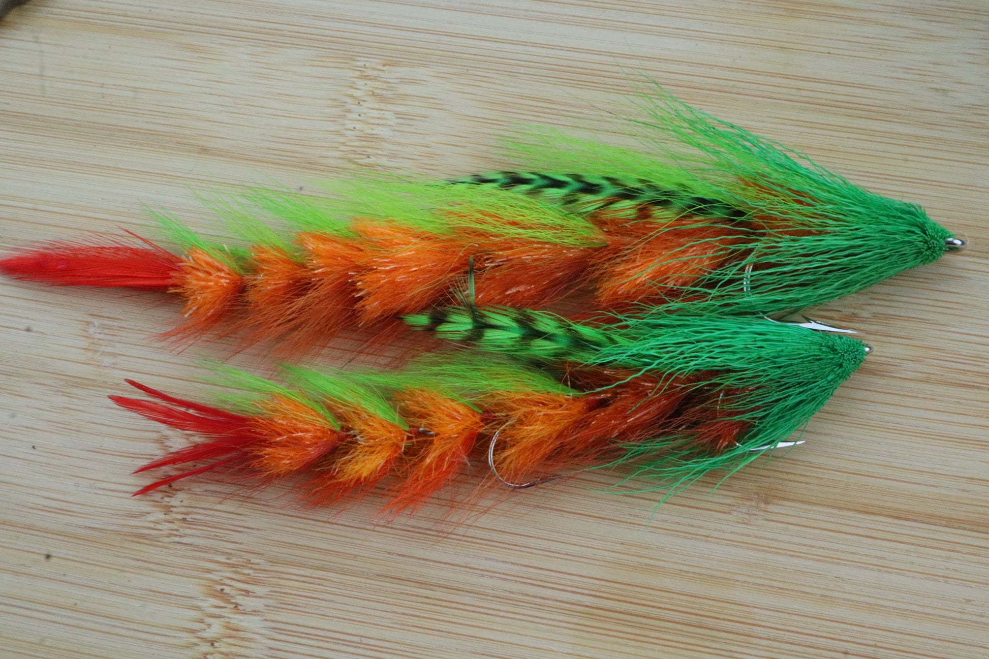 a close up of 2 flies on a wooden surface