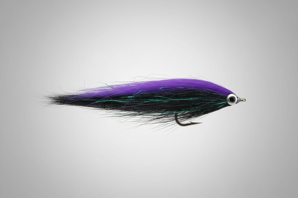 Fishing lure with purple and green body on a dark brown background