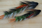 a couple of feathers sitting on top of a wooden table