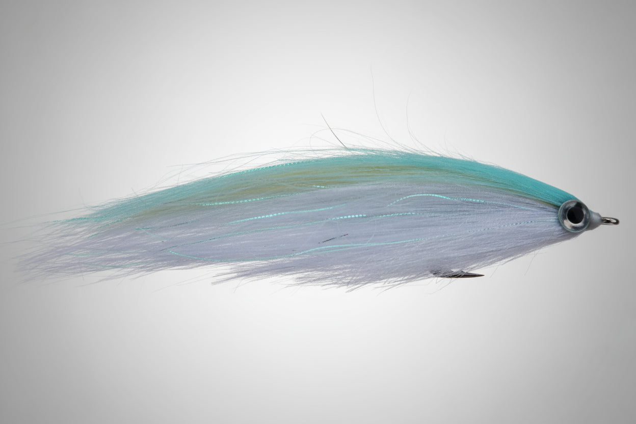 Fishing fly with teal and gray feathers on a dark brown background