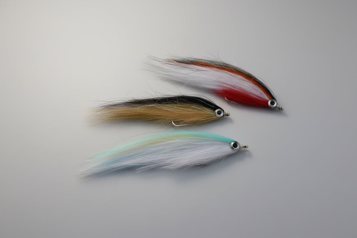Two fishing lures on a dark brown surface